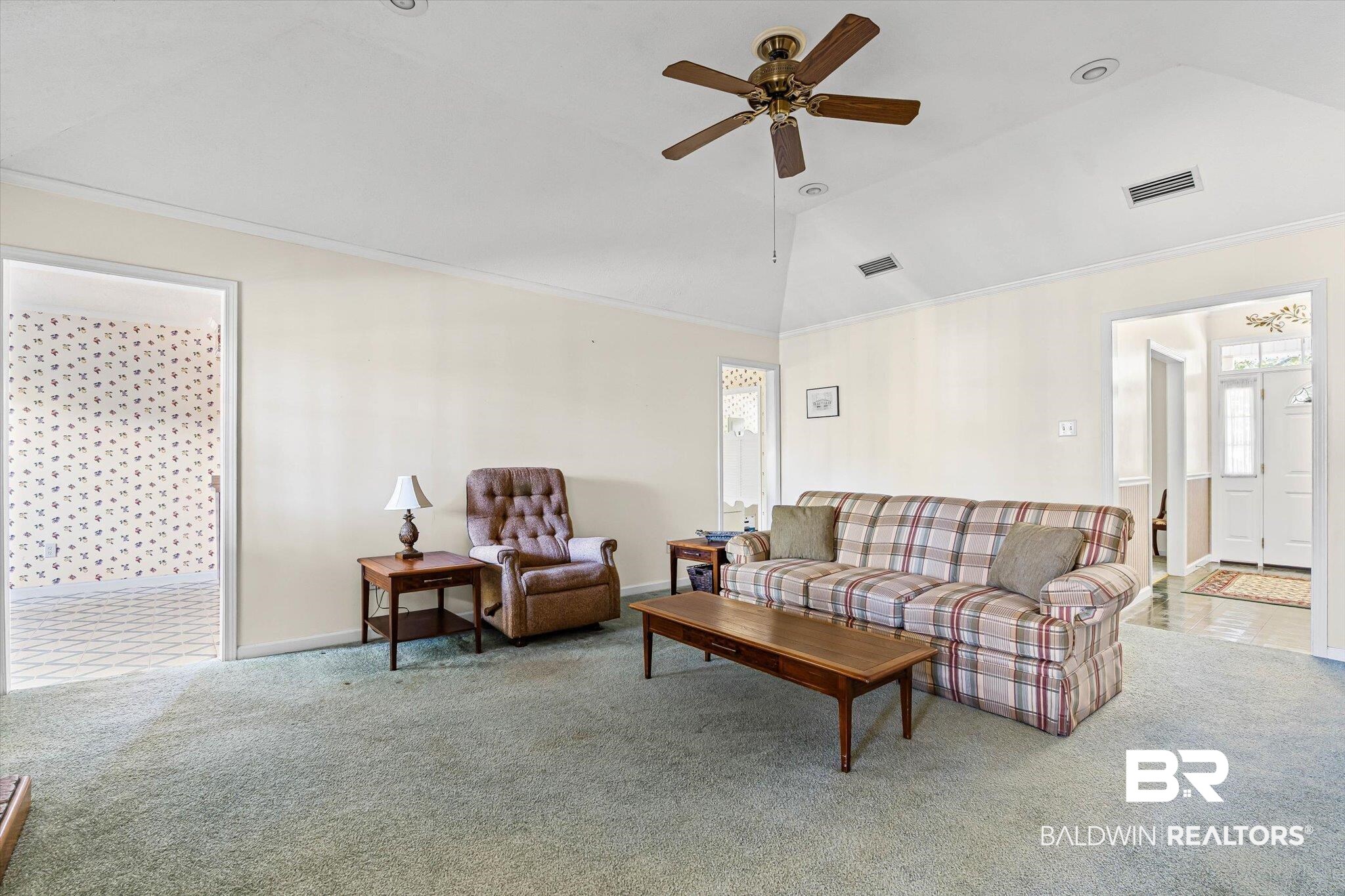 431 Simms Drive Saraland, AL 36571 - Photo 6 of 34 Carpeted living area featuring ornamental molding, lofted ceiling, and a ceiling fan