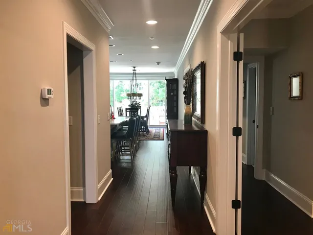 a view of a hallway with wooden floor fireplace and living room