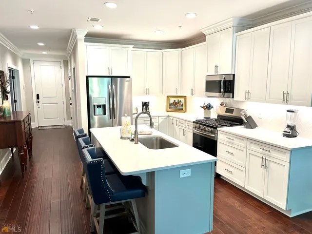 a kitchen with a sink stove and white cabinets