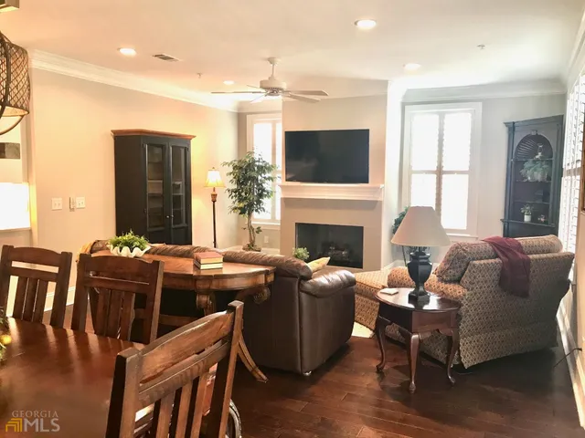 a living room with fireplace furniture and a flat screen tv