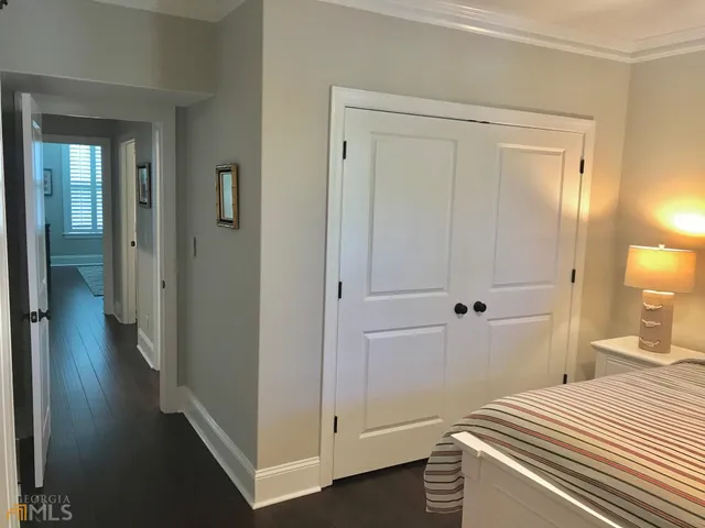 a bedroom with a bed and hallway