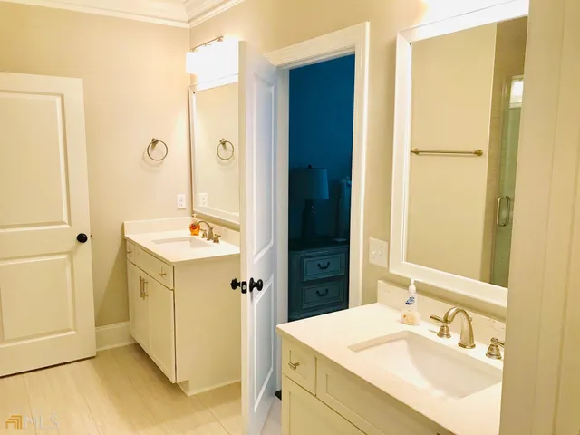 a bathroom with a sink mirror and a shower