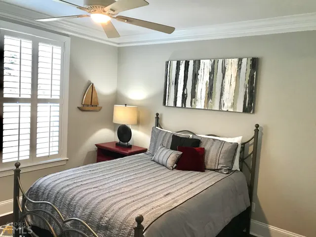 a bedroom with a large bed and a window