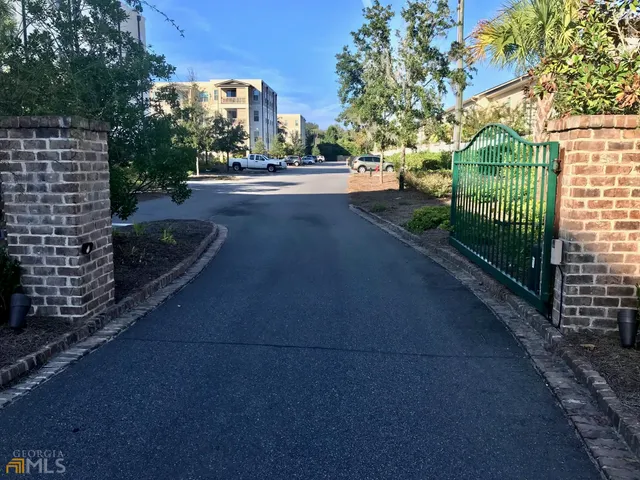 a view of a street with a large trees