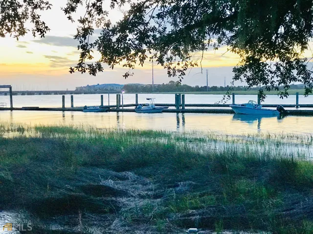 a view of a lake with trees in front of house