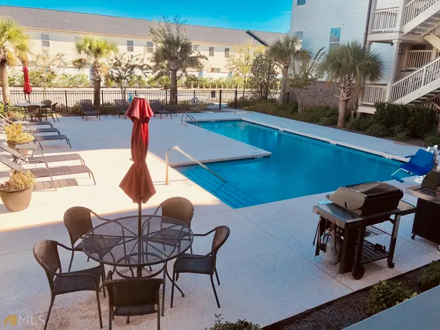 a view of a chairs and table in patio