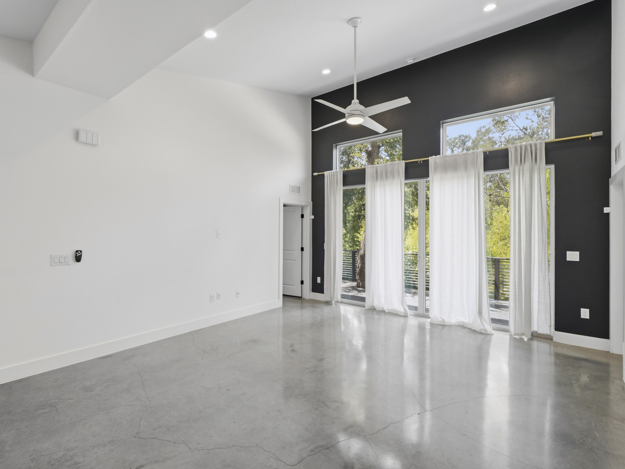 5005 Lott Avenue, Unit 2 Austin, TX 78721 - Photo 25 of 25 Lofty ceilings and a wall of windows illuminate this expansive living area.