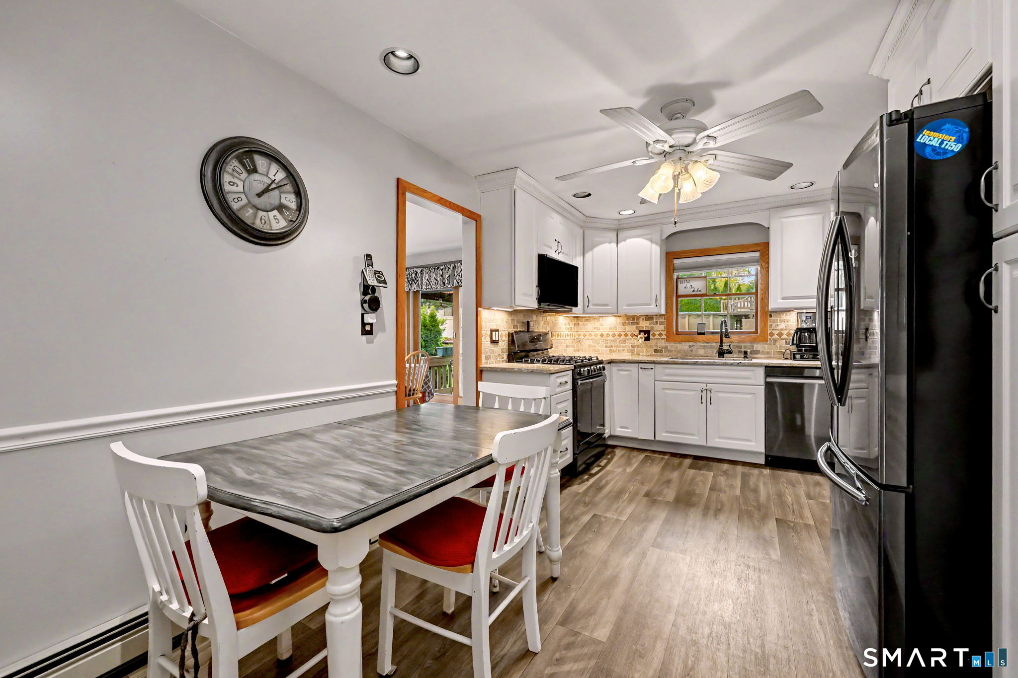 7 Merrill Road Trumbull, CT 06611 - Photo 9 of 40 a kitchen with a table chairs refrigerator and cabinets