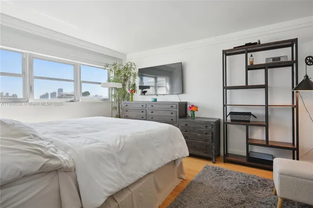 a bedroom with a bed and a television