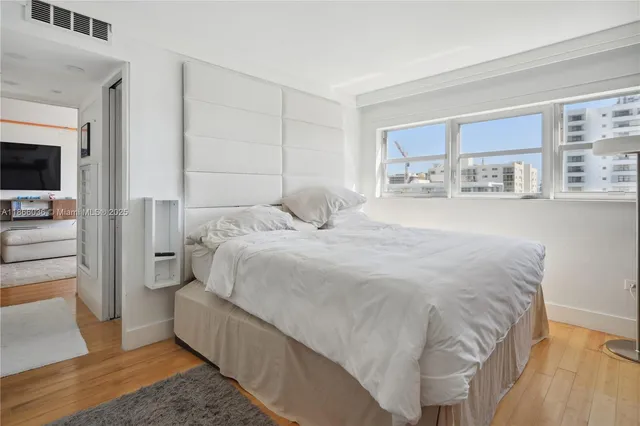 a large white bed in a white room