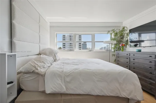 a bedroom with a bed and lamp