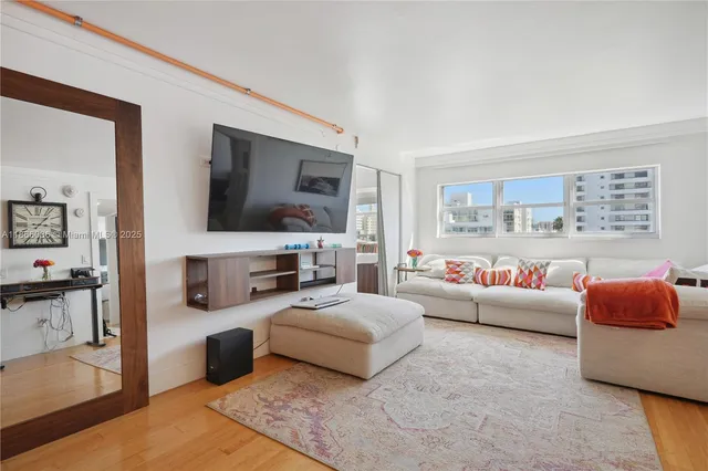 a kitchen with stainless steel appliances granite countertop a sink a stove cabinets and wooden floor