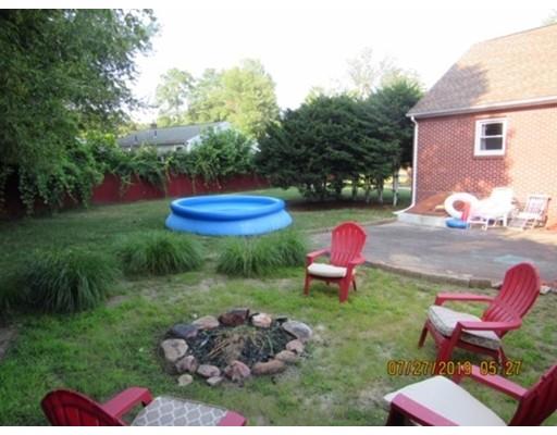 140 Nagle Street Springfield, MA 01151 - Photo 16 of 22 a view of a backyard with table and chairs a fire pit and plants