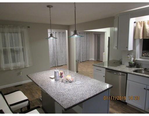 140 Nagle Street Springfield, MA 01151 - Photo 4 of 22 a kitchen with kitchen island granite countertop a sink a counter top space and cabinets