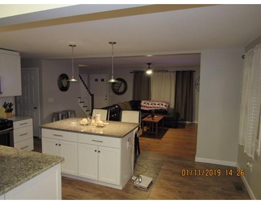 140 Nagle Street Springfield, MA 01151 - Photo 5 of 22 a kitchen with a sink a stove and chairs