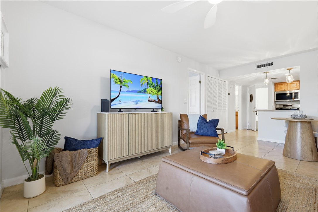 1830 Robalo Drive, Unit B102 Vero Beach, FL 32960 - Photo 5 of 33 a living room with furniture and flat screen tv
