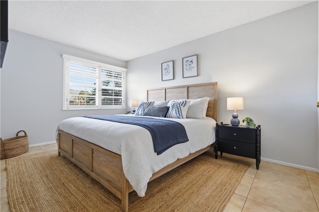 1830 Robalo Drive, Unit B102 Vero Beach, FL 32960 - Photo 9 of 33 a bedroom with a bed and a lamp