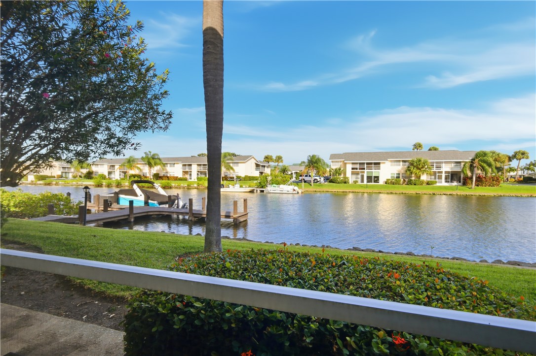 1830 Robalo Drive, Unit B102 Vero Beach, FL 32960 - Photo 10 of 33 a view of a lake with boats and trees in the background