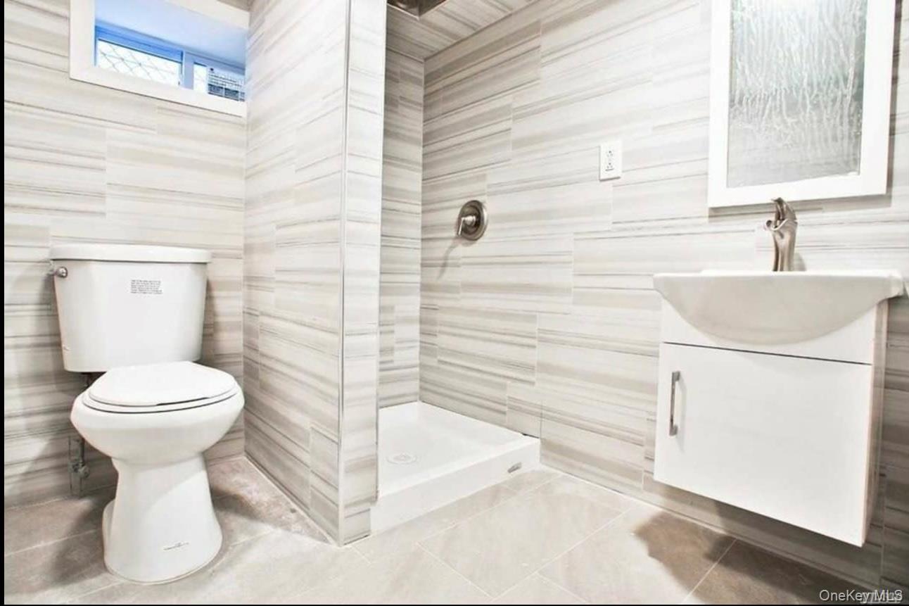 194-56 114th Road Queens, NY 11412 - Photo 13 of 16 a bathroom with a sink and a toilet