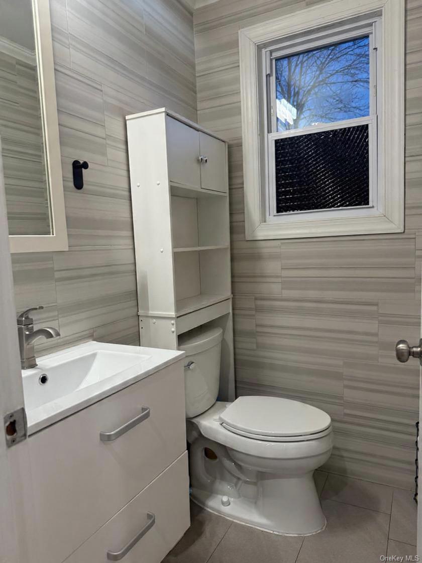 194-56 114th Road Queens, NY 11412 - Photo 8 of 16 a bathroom with a toilet a sink and mirror