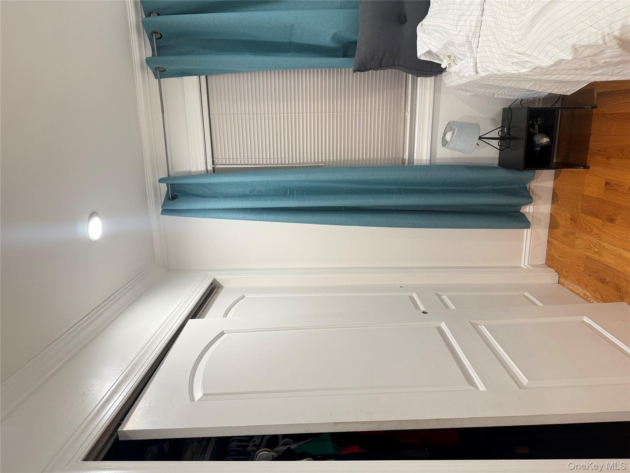 194-56 114th Road Queens, NY 11412 - Photo 10 of 16 a view of a bedroom with a bed and a window