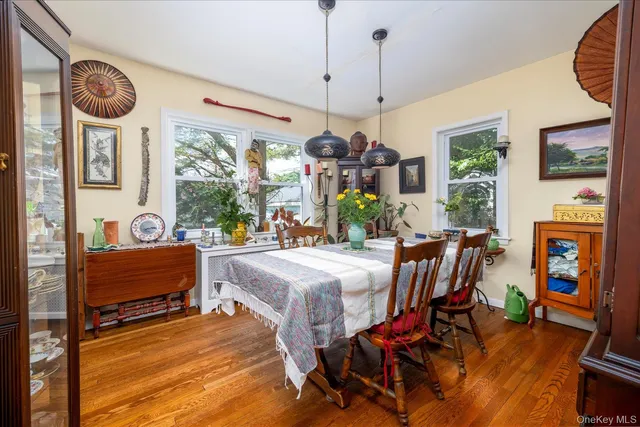 a view of a dining room with furniture a chandelier and wooden floor