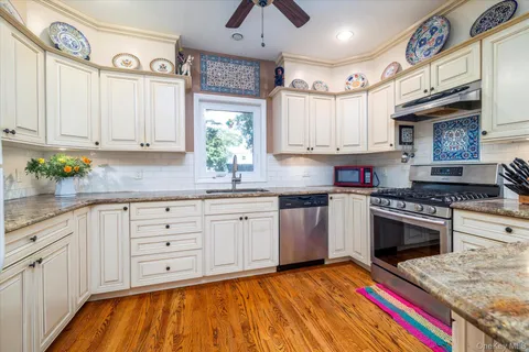 a kitchen with cabinets appliances and a window