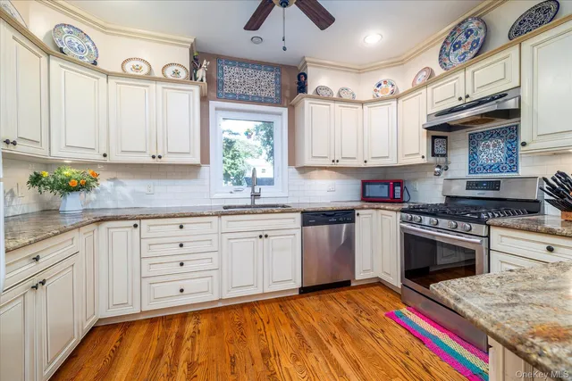 a kitchen with cabinets appliances and a window