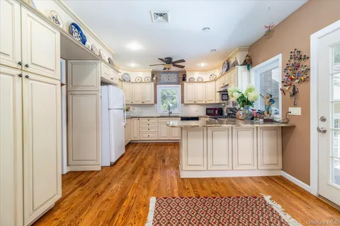 a kitchen with stainless steel appliances granite countertop a refrigerator and a stove top oven