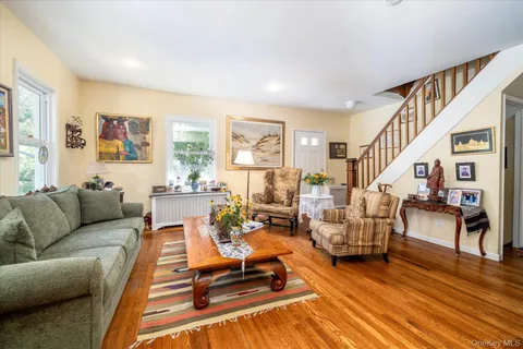 a living room with furniture or couch and a wooden floor