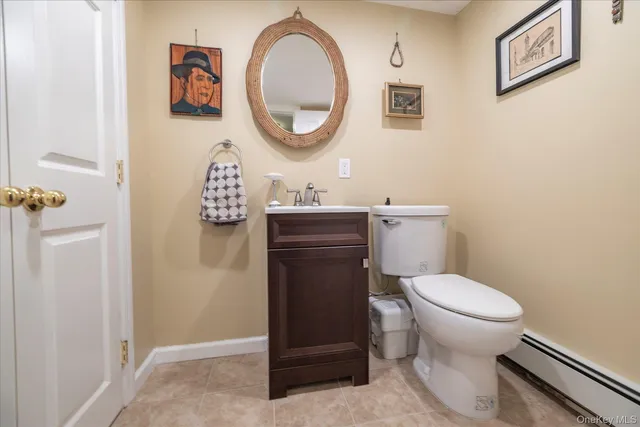 a bathroom with a toilet a sink and a mirror