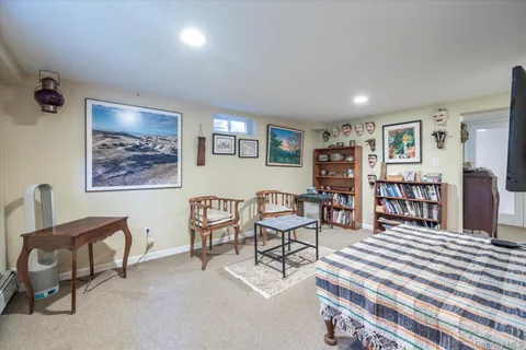 a bedroom with furniture and a bookshelf