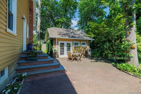 a view of a house with sitting area and garden