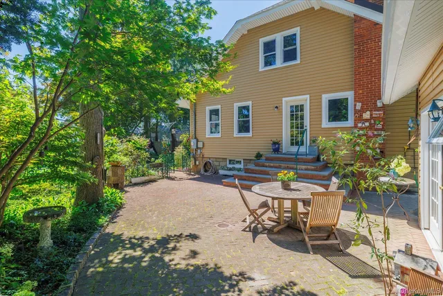 a backyard of a house with yard barbeque oven and outdoor seating