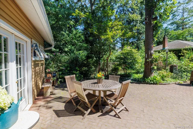 a view of a patio with table and chairs and potted plants