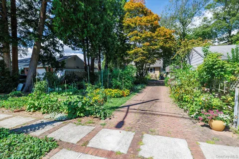 a view of a garden with flowers and trees