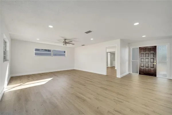 wooden floor in an empty room with a window
