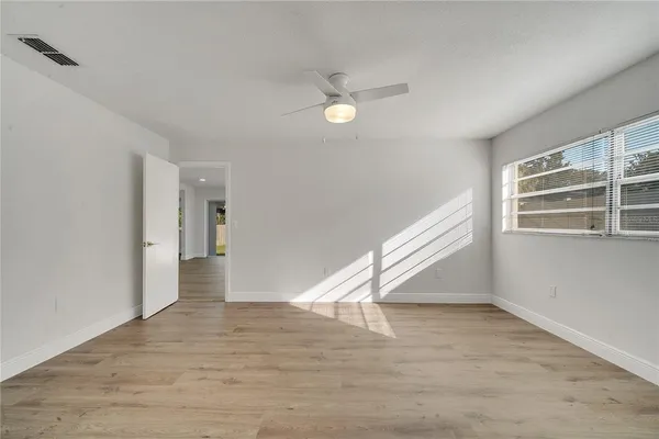 wooden floor in an empty room with a window