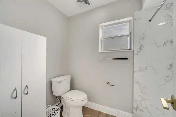 a bathroom with a toilet and a shower