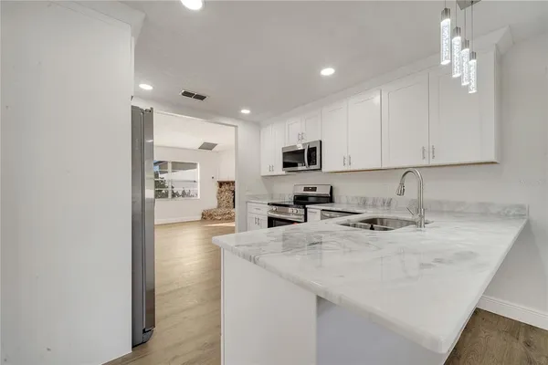 a kitchen with sink a stove and cabinets