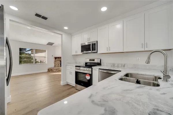 a kitchen with sink a stove and refrigerator