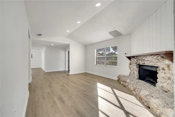 a view of an empty room and fire place