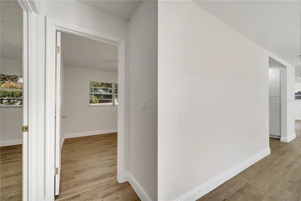 a view of a hallway with wooden floor