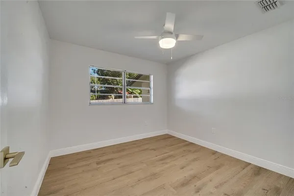 wooden floor in an empty room with a window