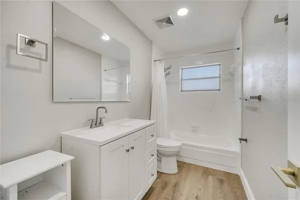 a bathroom with a sink toilet tub and shower
