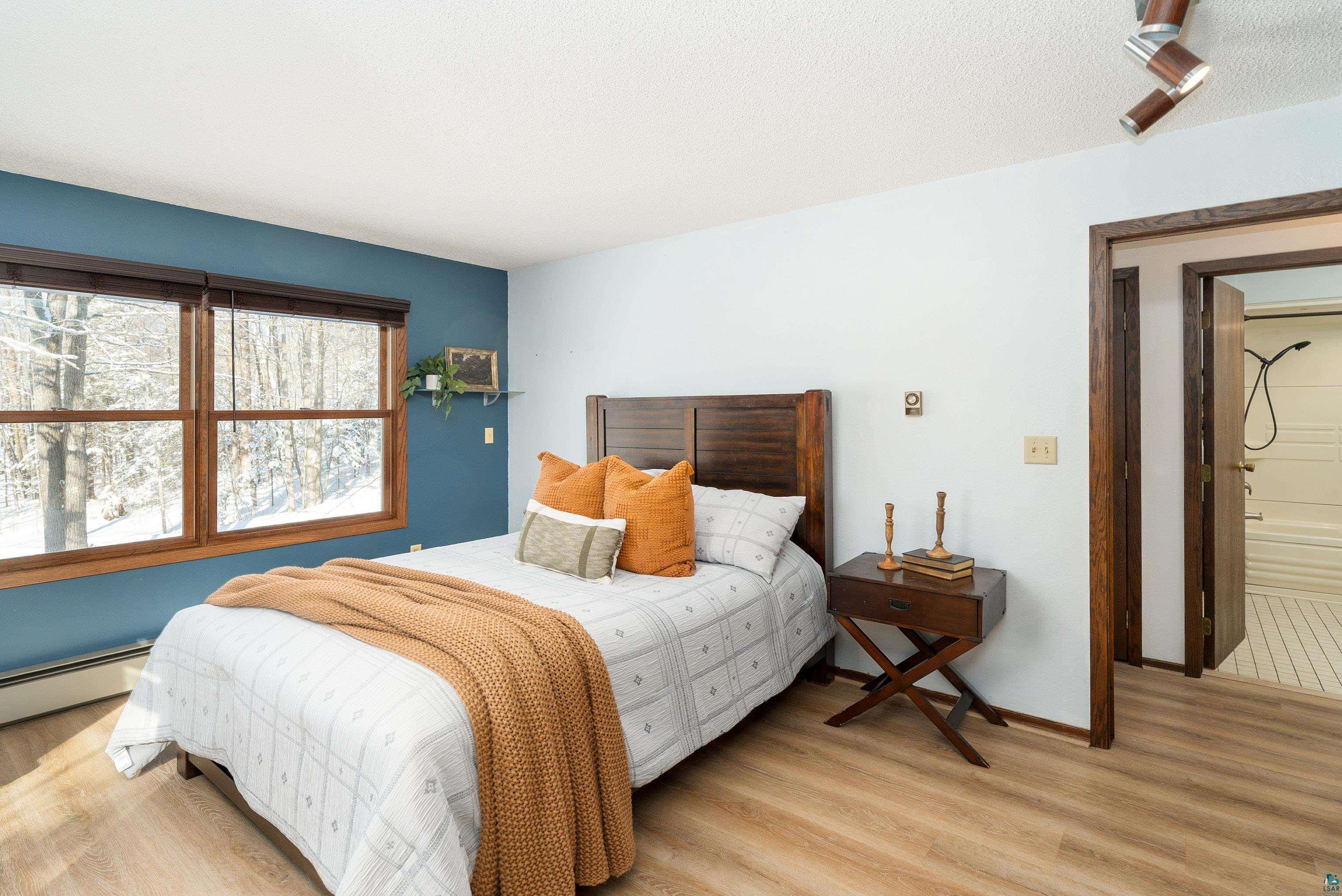 5947 East St Louis River Road Proctor, MN 55810 - Photo 19 of 47 Bedroom with light wood-style floors and a textured ceiling