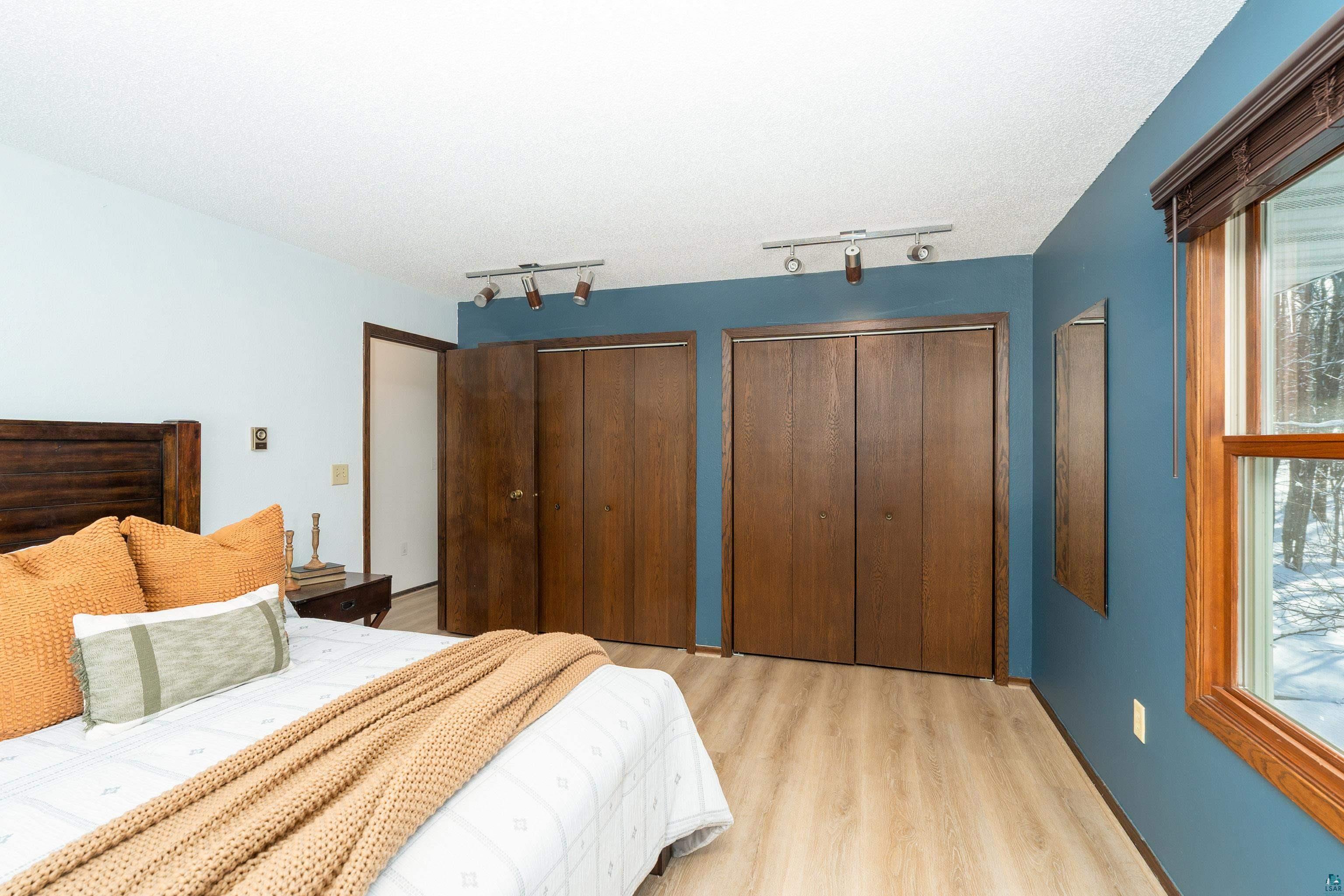 5947 East St Louis River Road Proctor, MN 55810 - Photo 20 of 47 Bedroom featuring two closets and light wood-style floors