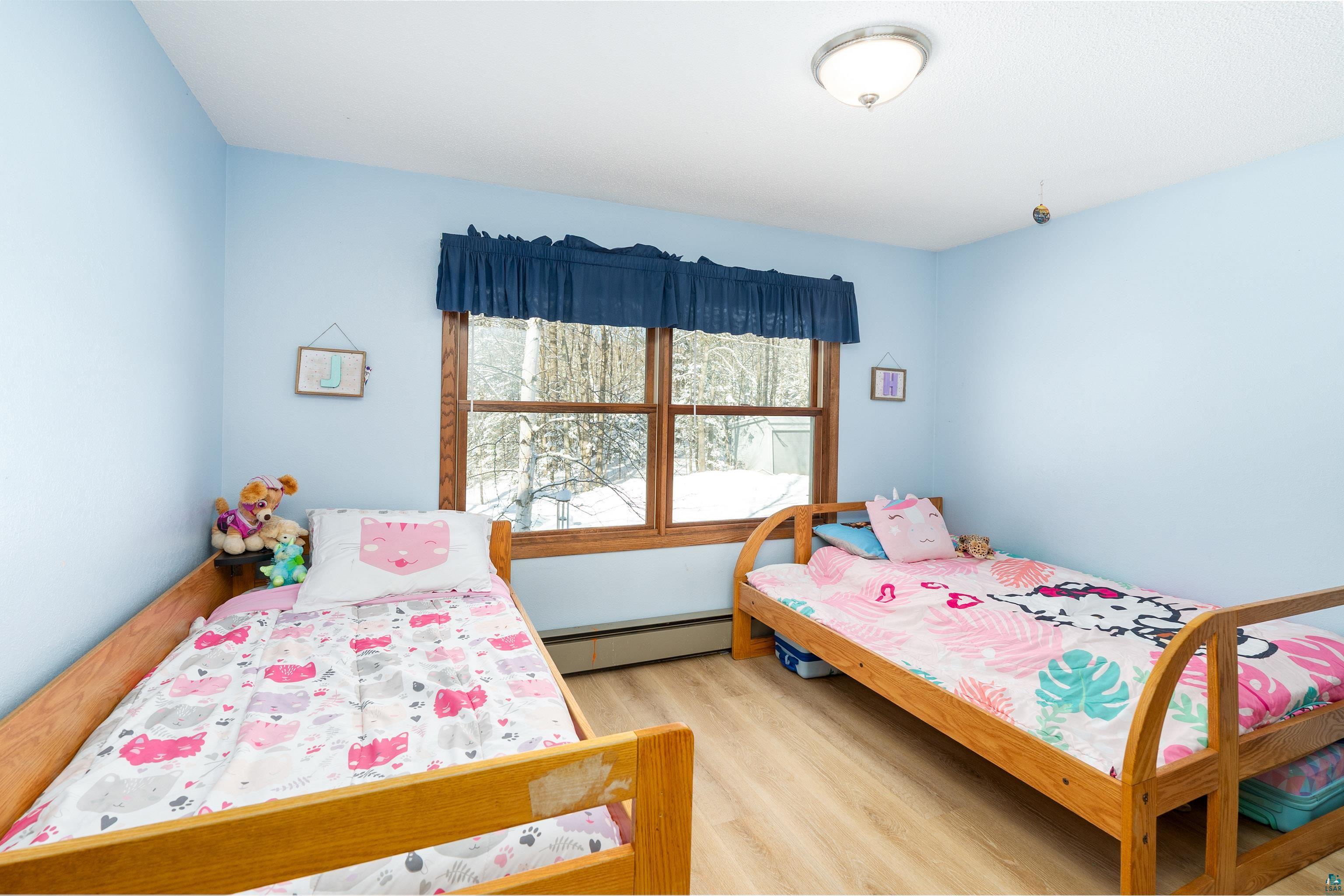 5947 East St Louis River Road Proctor, MN 55810 - Photo 22 of 47 Bedroom featuring light wood-style floors and baseboard heating