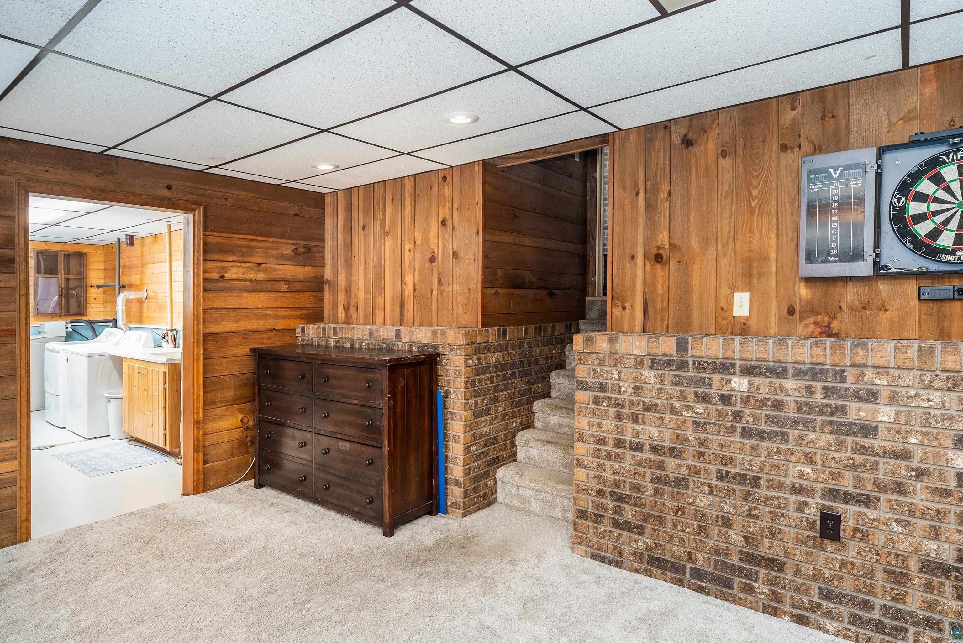 5947 East St Louis River Road Proctor, MN 55810 - Photo 29 of 47 Bar with carpet flooring, wood walls, a drop ceiling, recessed lighting, and independent washer and dryer