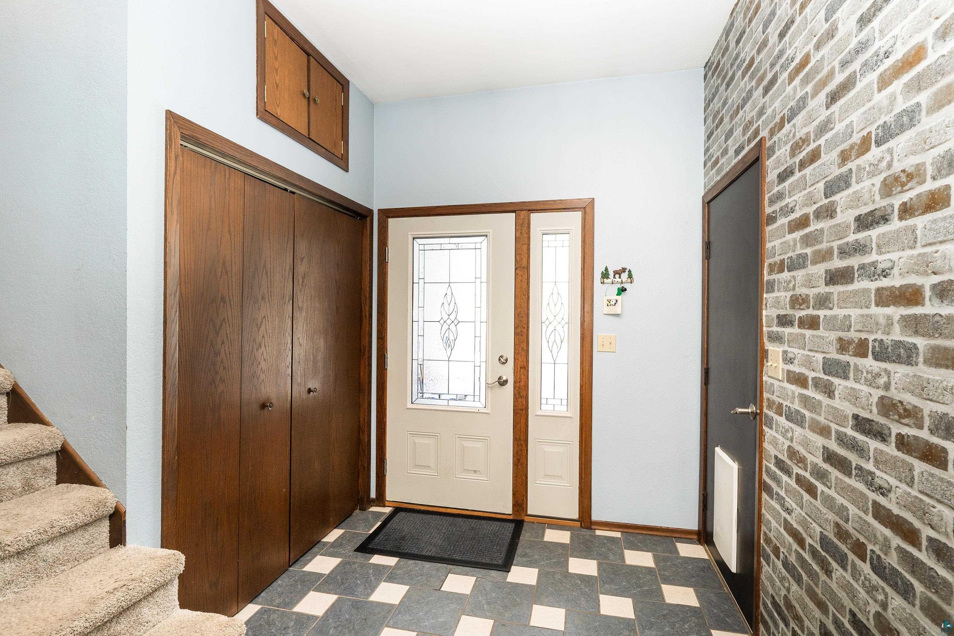 5947 East St Louis River Road Proctor, MN 55810 - Photo 8 of 47 Entryway featuring light flooring and brick wall